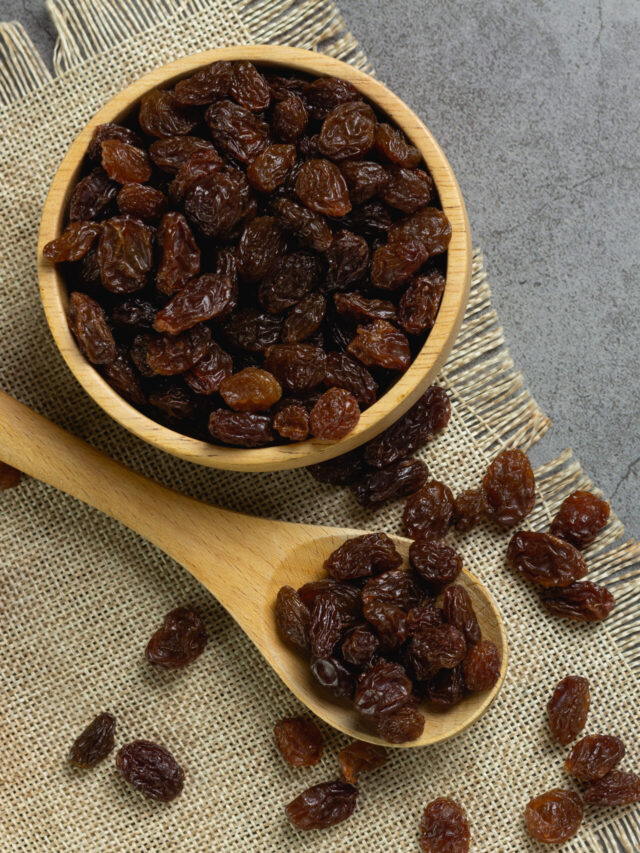 Dried raisins in bowl on table